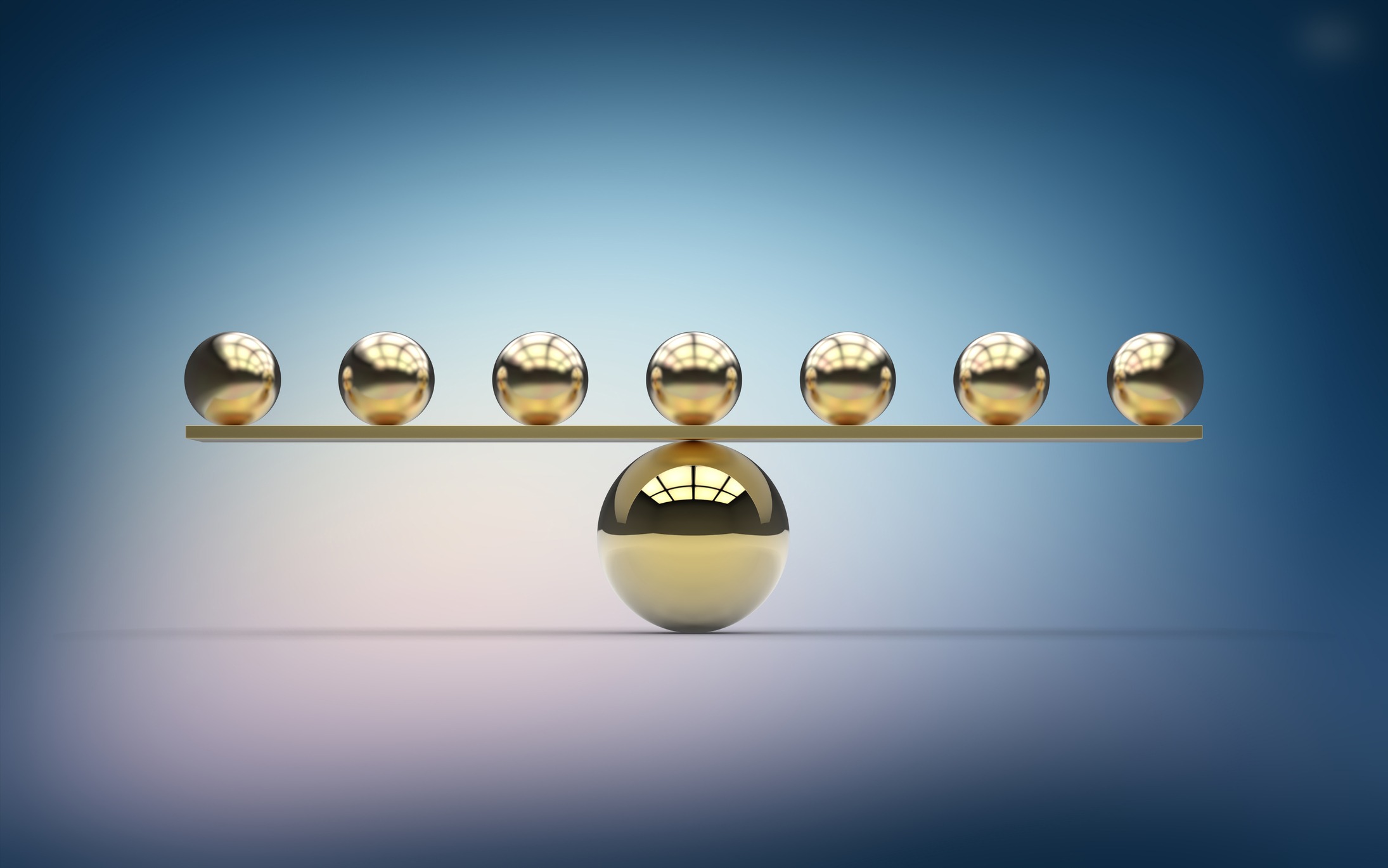 Seven small gold metallic balls balancing on one large gold ball. Imbalance. Weight scale.